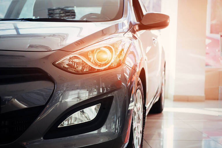 The Headlights And The Hood Of A Black Sports Car